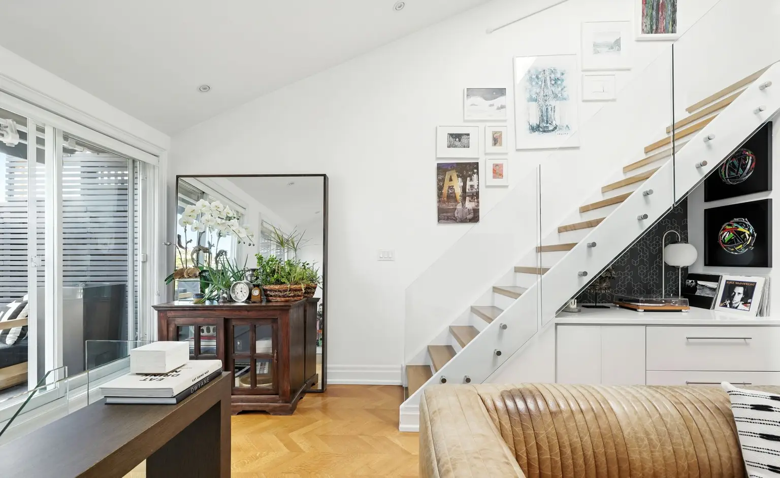 Staircase above a leather sofa