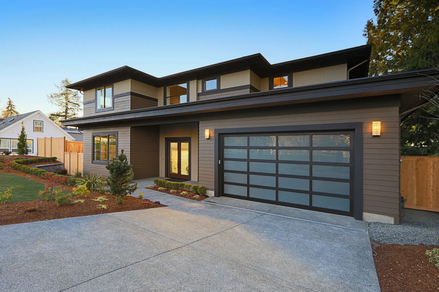 Modern two-storey home with a glass garage door