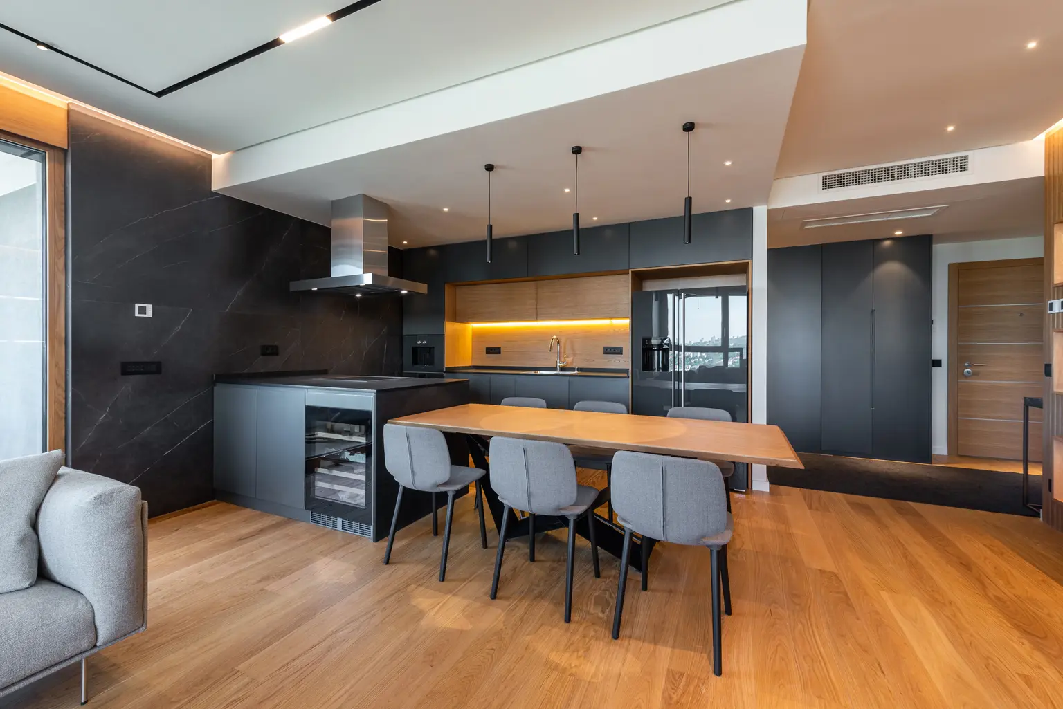 Dark modern kitchen with a timber dining table