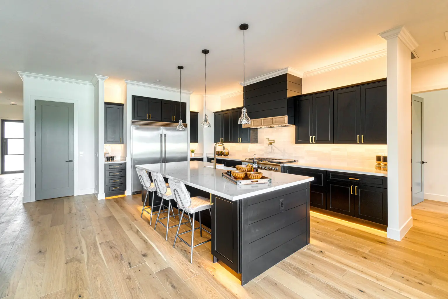Dark kitchen island with pendant lights