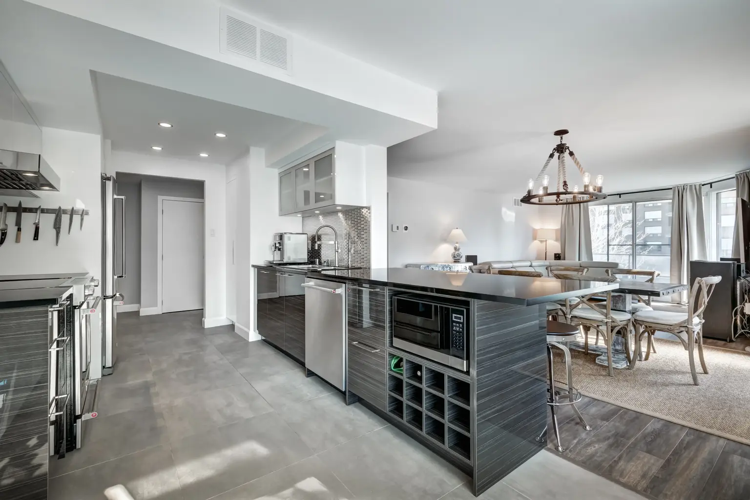Open kitchen and dining room with a chandelier