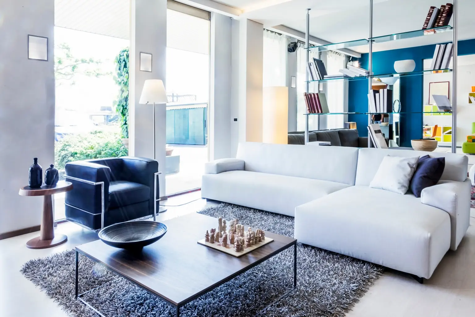 Modern living room with a glass wall onto the garden