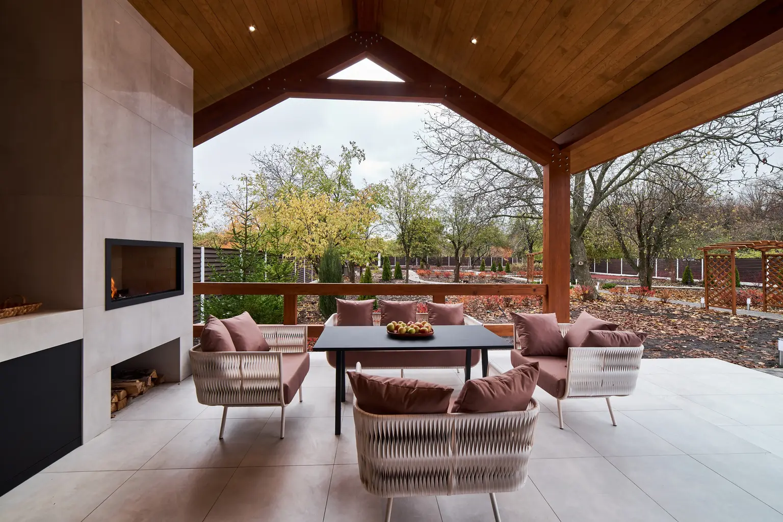 Covered patio with an outdoor fireplace and dining area