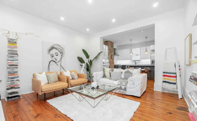 Living room with a large rug and glass coffee table