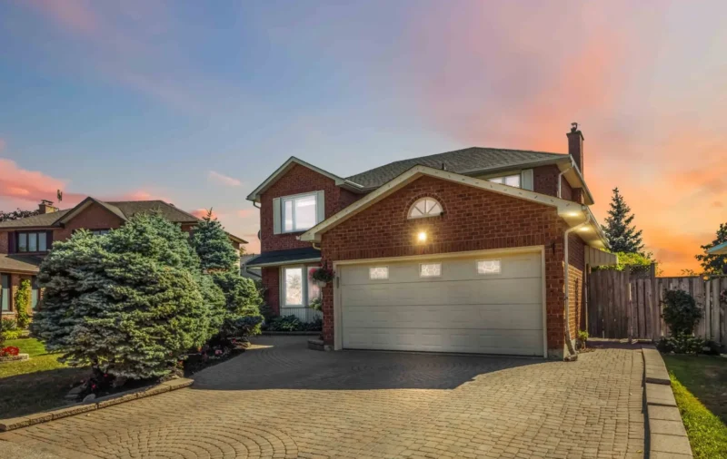 Brick home with a double garage at sunset