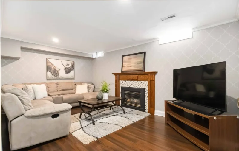 Finished basement living room with a fireplace