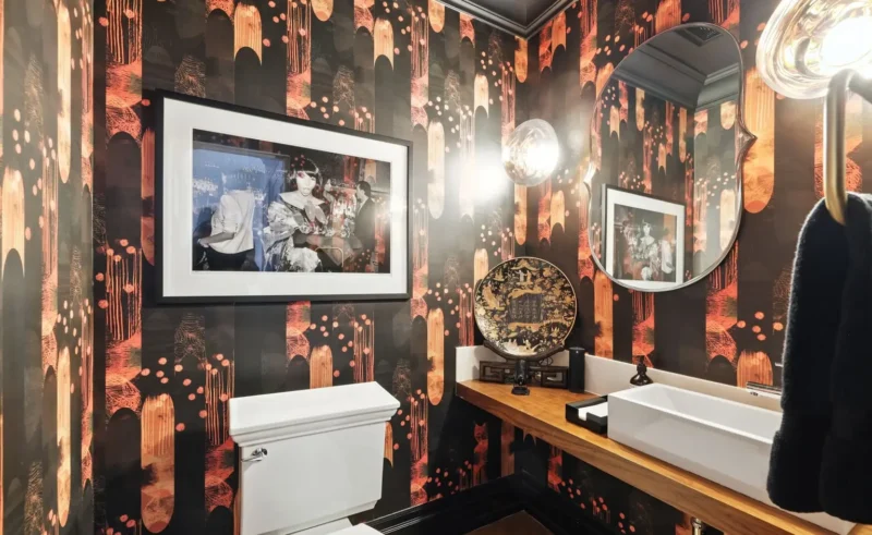 Powder room with dramatic wallpaper