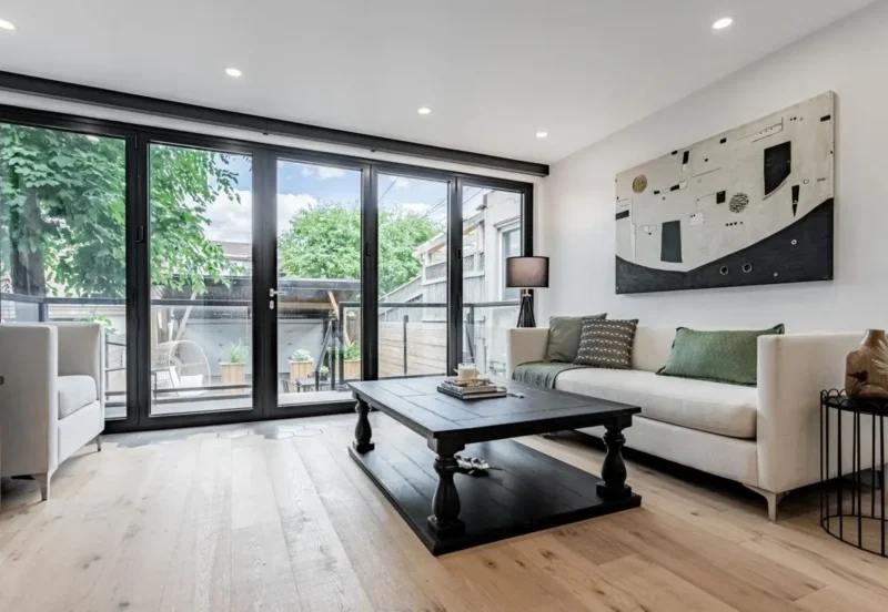 Open living room with black-framed glass doors